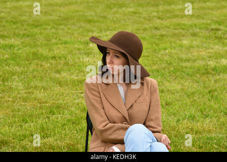 Moscow - June 04: Sad young woman sitting alone while it`s raining on June 04, 2016 in Moscow, Russia Stock Photo